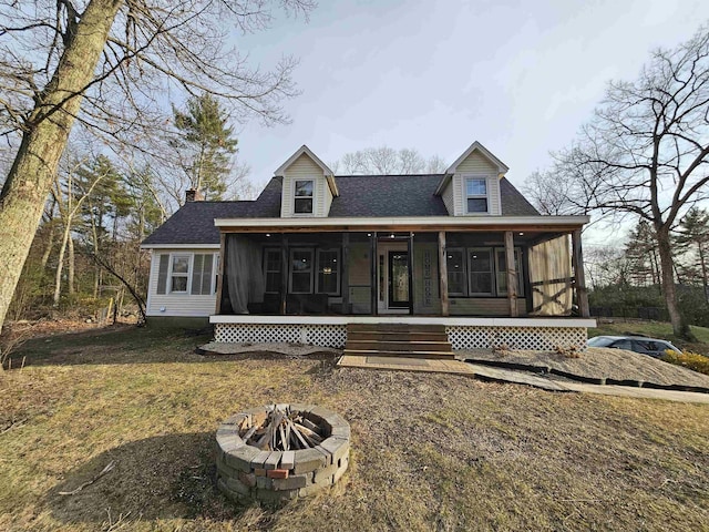 436 Mammoth Rd, Pelham, NH 03076 - view of front facade featuring a fire pit, a sunroom, roof with shingles, and a front lawn