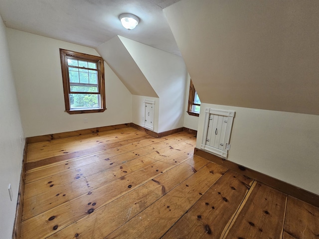 436 Mammoth Rd, Pelham, NH 03076 - additional living space with light wood-type flooring, vaulted ceiling, and baseboards
