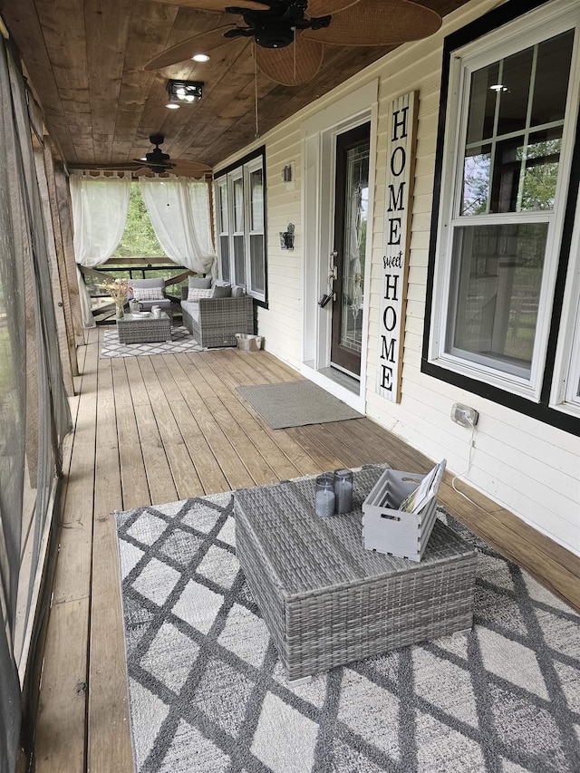 436 Mammoth Rd, Pelham, NH 03076 - wooden porch with ceiling fan and outdoor lounge area