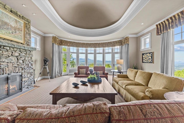1097 Taber Ridge Rd, Stowe, VT 05672 - living room featuring ornamental molding, healthy amount of natural light, baseboards, a tray ceiling, and a stone fireplace