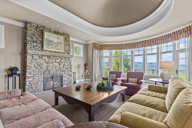 1097 Taber Ridge Rd, Stowe, VT 05672 - living area featuring a stone fireplace, crown molding, a tray ceiling, recessed lighting, and a mountain view