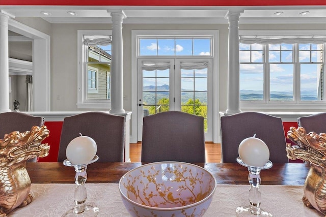 1097 Taber Ridge Rd, Stowe, VT 05672 - dining area with decorative columns, crown molding, plenty of natural light, and recessed lighting
