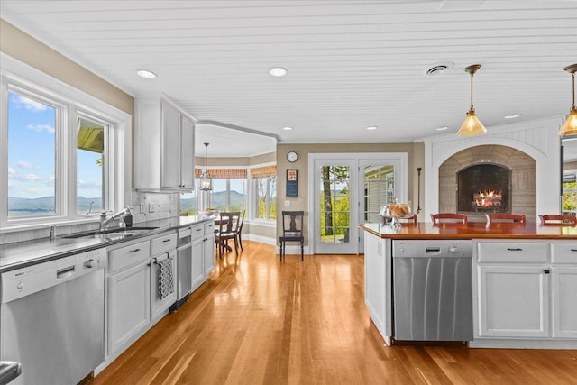 1097 Taber Ridge Rd, Stowe, VT 05672 - kitchen with stainless steel dishwasher, healthy amount of natural light, light wood-style floors, recessed lighting, and crown molding