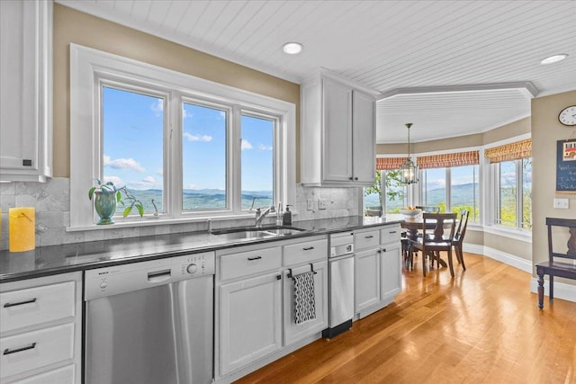 1097 Taber Ridge Rd, Stowe, VT 05672 - kitchen with stainless steel dishwasher, dark countertops, a chandelier, light wood-type flooring, and healthy amount of natural light