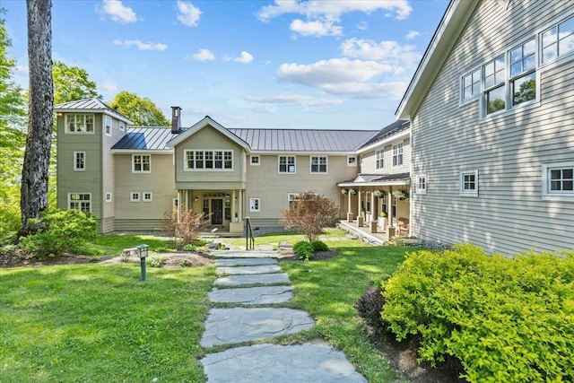 1097 Taber Ridge Rd, Stowe, VT 05672 - back of property featuring a standing seam roof, a lawn, metal roof, and a porch