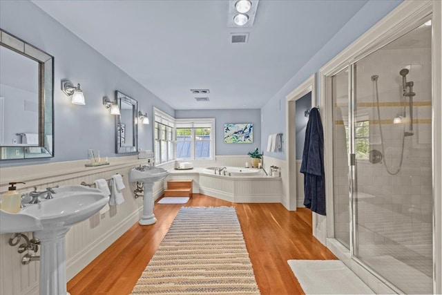 1097 Taber Ridge Rd, Stowe, VT 05672 - full bathroom featuring a garden tub, a shower stall, and wood finished floors