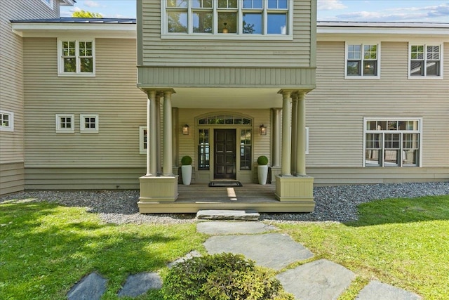 1097 Taber Ridge Rd, Stowe, VT 05672 - view of exterior entry with a porch and a lawn