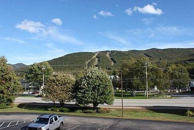 227 Main St Unit 232, Lincoln, NH 03251 - view of home's community with a mountain view and uncovered parking