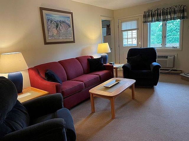 227 Main St Unit 232, Lincoln, NH 03251 - carpeted living area featuring an AC wall unit
