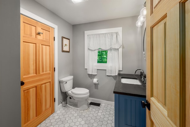 47 Hollow View Rd, Stowe, VT 05672 - bathroom featuring vanity, toilet, and baseboards