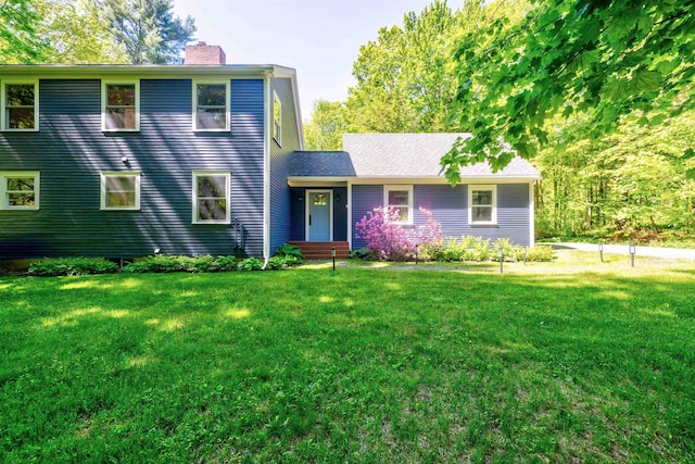 47 Hollow View Rd, Stowe, VT 05672 - view of front facade with a chimney and a front yard