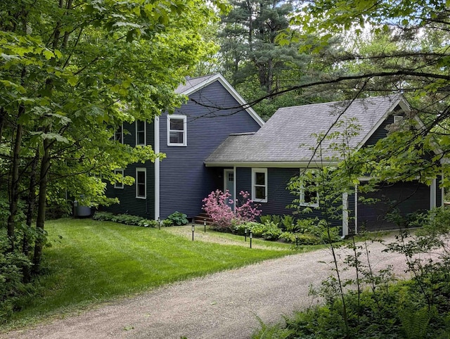 47 Hollow View Rd, Stowe, VT 05672 - view of front of home with a front lawn, dirt driveway, and an attached garage