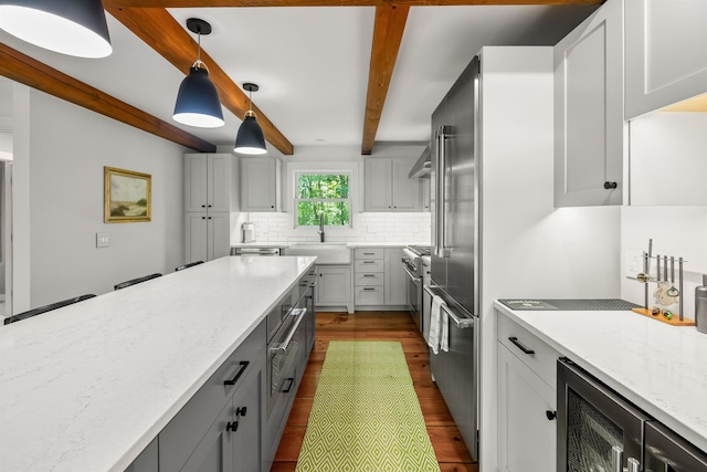 47 Hollow View Rd, Stowe, VT 05672 - kitchen with a sink, dark wood-type flooring, beverage cooler, backsplash, and high end appliances
