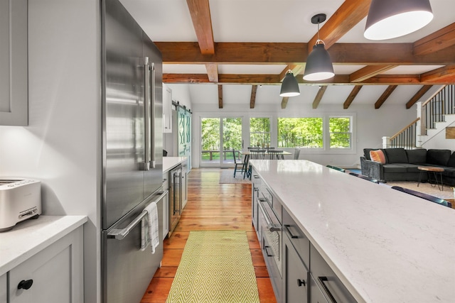 47 Hollow View Rd, Stowe, VT 05672 - kitchen featuring high end fridge, light wood-type flooring, beamed ceiling, light stone counters, and pendant lighting