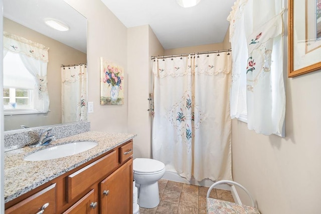 7 Elystan Cir, Nashua, NH 03064 - bathroom featuring toilet, vanity, stone finish floors, and curtained shower