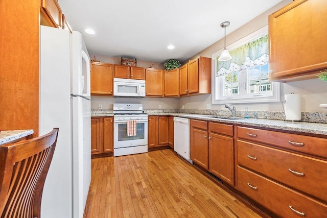 7 Elystan Cir, Nashua, NH 03064 - kitchen featuring white appliances, a sink, light wood-style flooring, brown cabinets, and recessed lighting