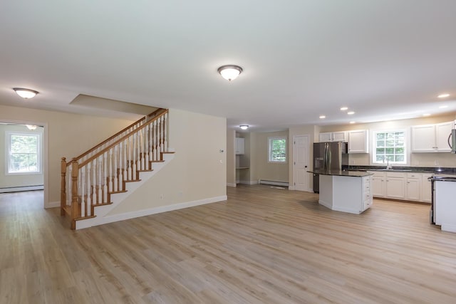 38 Howard Hill Rd, Jaffrey, NH 03452 - kitchen featuring stainless steel fridge with ice dispenser, a baseboard radiator, a sink, dark countertops, and light wood finished floors