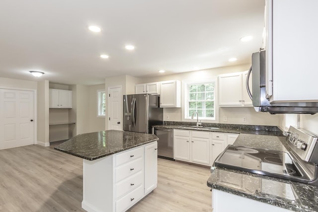 38 Howard Hill Rd, Jaffrey, NH 03452 - kitchen with stainless steel appliances, a sink, a center island, dark stone counters, and light wood-style floors