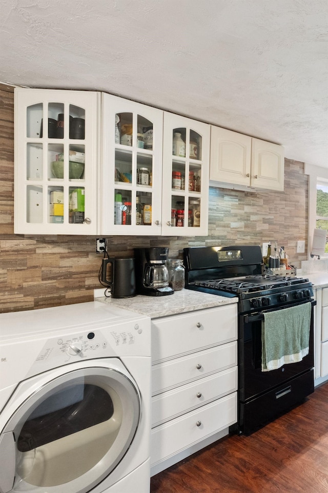 194 Pleasant St, Bristol, NH 03222 - kitchen featuring washer / dryer, gas stove, glass insert cabinets, white cabinets, and a textured ceiling