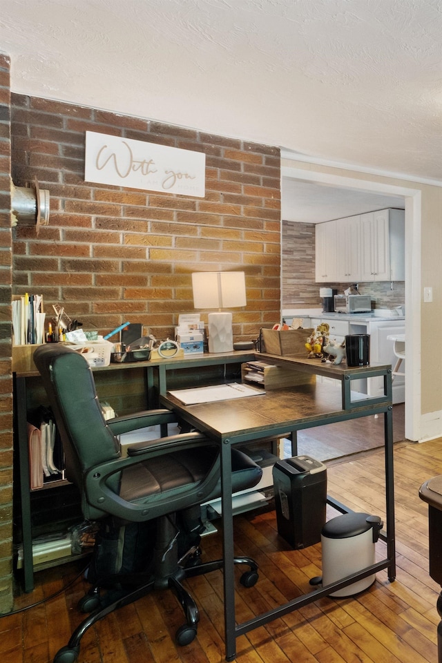 194 Pleasant St, Bristol, NH 03222 - office space with light wood-style flooring, brick wall, and baseboards