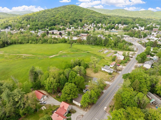 194 Pleasant St, Bristol, NH 03222 - aerial perspective of suburban area featuring mountains and a heavily wooded area