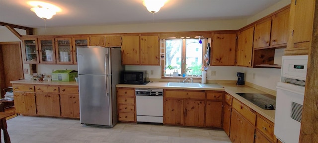 21 Triton Dr, Rye, NH 03870 - kitchen featuring black appliances, light countertops, a sink, and brown cabinetry