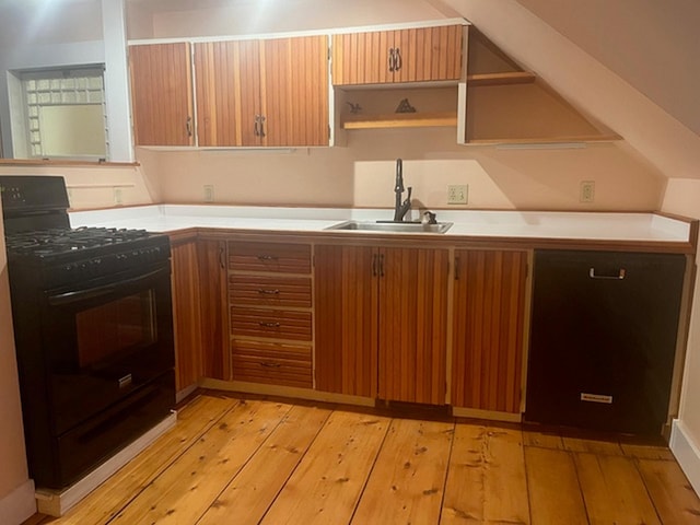 6 On The Cmn Unit 5, Lyme, NH 03768 - kitchen featuring black range with gas stovetop, open shelves, light wood-style flooring, light countertops, and brown cabinets