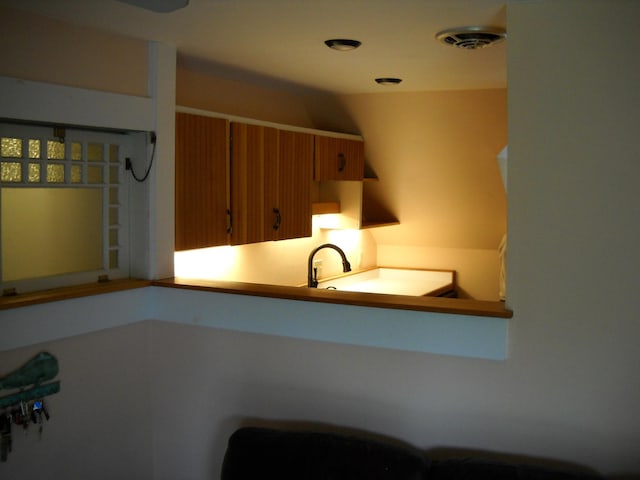 6 On The Cmn Unit 5, Lyme, NH 03768 - kitchen featuring brown cabinetry and a sink