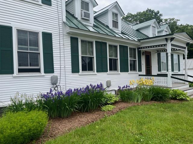 6 On The Cmn Unit 5, Lyme, NH 03768 - view of home's exterior with a lawn and a metal roof