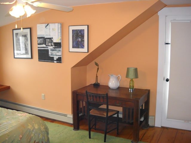 6 On The Cmn Unit 5, Lyme, NH 03768 - bedroom with a baseboard radiator, wood finished floors, and a desk