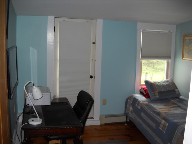 6 On The Cmn Unit 5, Lyme, NH 03768 - bedroom with a baseboard heating unit, wood finished floors, and an office area