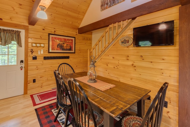 3233 Stinson Lake Rd, Ellsworth, NH 03266 - dining room featuring stairs, wood walls, lofted ceiling, light wood-style flooring, and wooden ceiling