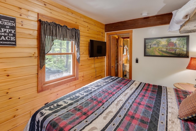3233 Stinson Lake Rd, Ellsworth, NH 03266 - bedroom featuring wooden walls and ensuite bathroom