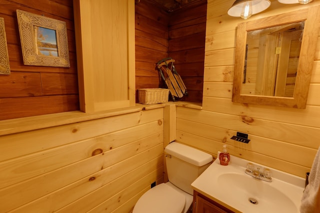 3233 Stinson Lake Rd, Ellsworth, NH 03266 - bathroom featuring toilet, wood walls, and vanity