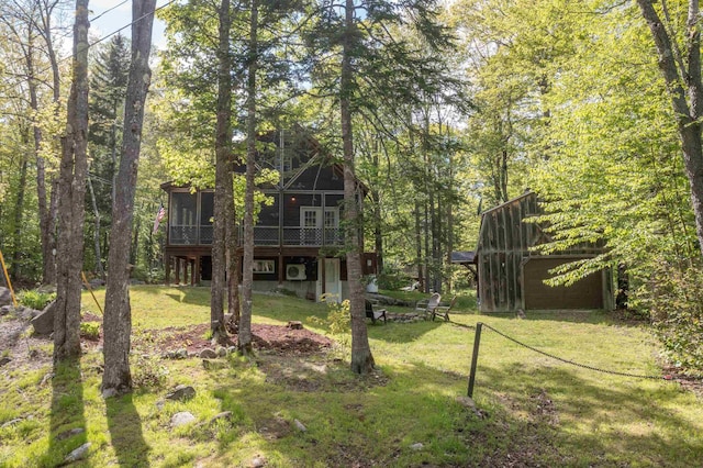 3233 Stinson Lake Rd, Ellsworth, NH 03266 - view of grassy yard featuring a sunroom and a garage
