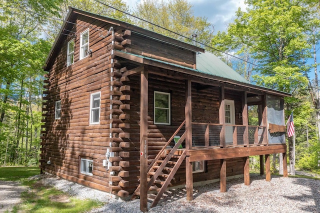 3233 Stinson Lake Rd, Ellsworth, NH 03266 - view of front of home featuring log exterior, metal roof, stairway, and a wooden deck