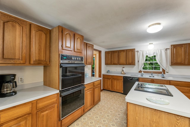 210 Province Rd, Belmont, NH 03220 - kitchen with black appliances, a sink, brown cabinetry, and light countertops