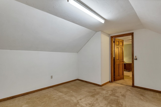 210 Province Rd, Belmont, NH 03220 - additional living space with light carpet, vaulted ceiling, and baseboards