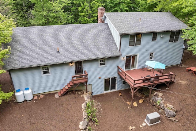 210 Province Rd, Belmont, NH 03220 - back of house with roof with shingles, a deck, a chimney, and a forest view