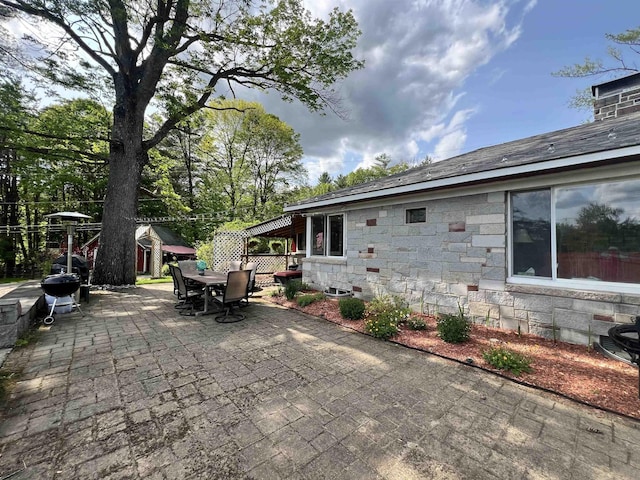 6 Nightingale Ln, Grantham, NH 03753 - view of patio featuring outdoor dining space, a grill, and an outbuilding