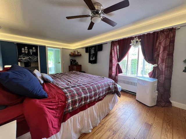 6 Nightingale Ln, Grantham, NH 03753 - bedroom featuring radiator, multiple windows, wood finished floors, and ceiling fan