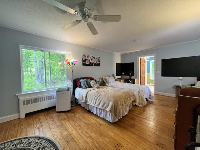 6 Nightingale Ln, Grantham, NH 03753 - bedroom with radiator heating unit, baseboards, light wood-style flooring, ceiling fan, and crown molding