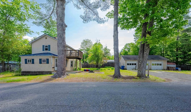 18 Pine Ave, Claremont, NH 03743 - view of front facade featuring a balcony, a detached garage, and metal roof