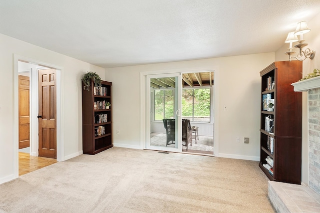5 Christian Dr, Nashua, NH 03063 - unfurnished living room featuring carpet floors, baseboards, and a textured ceiling