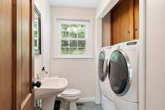 5 Christian Dr, Nashua, NH 03063 - half bathroom with washing machine and clothes dryer, baseboards, tile patterned floors, toilet, and a sink