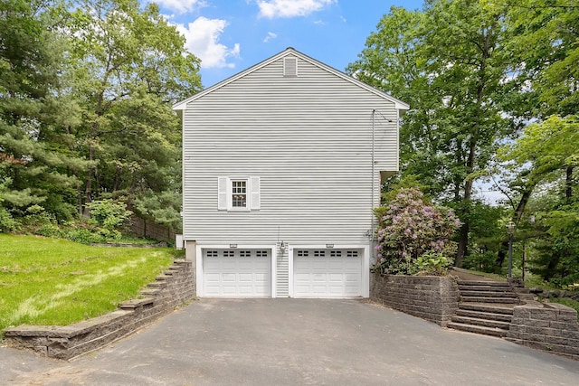 5 Christian Dr, Nashua, NH 03063 - view of home's exterior featuring driveway, an attached garage, and a lawn