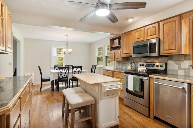 5 Christian Dr, Nashua, NH 03063 - kitchen featuring stainless steel appliances, decorative backsplash, and light wood-style floors