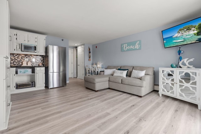 415 Ocean Blvd Unit 2B, Hampton, NH 03842 - living room featuring a bar, light wood-type flooring, and a baseboard heating unit