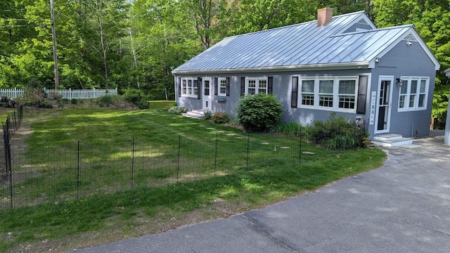 144 Bradford Rd, Henniker, NH 03242 - view of front of home with entry steps, a standing seam roof, a chimney, and metal roof