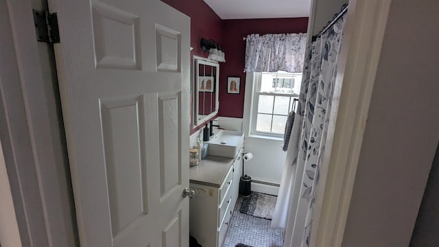 144 Bradford Rd, Henniker, NH 03242 - full bath featuring vanity, a baseboard heating unit, tile patterned flooring, and curtained shower